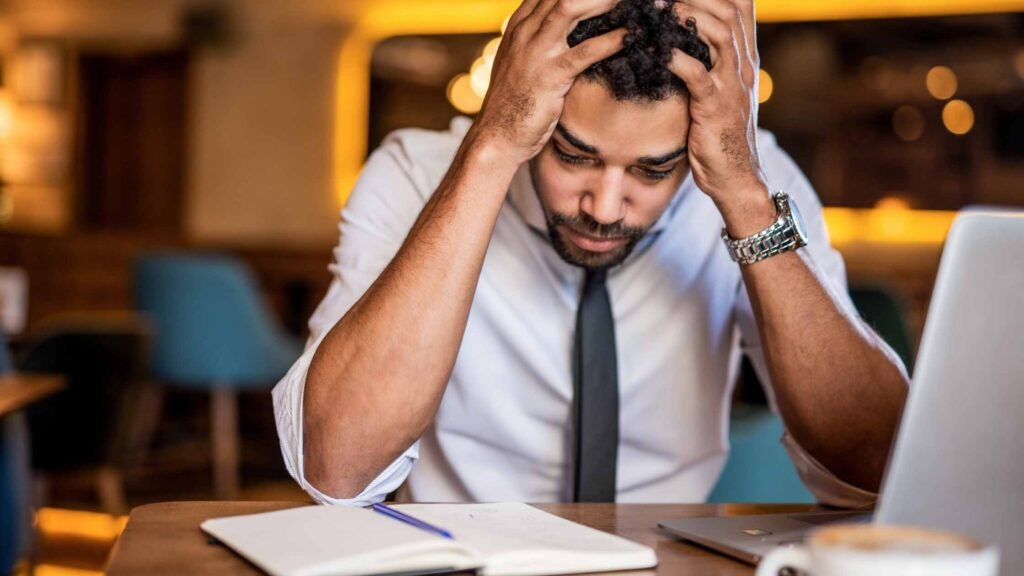 Technophobia employee holding his head