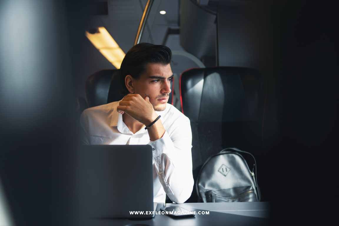 Business Travel Man peeking through Flight Window