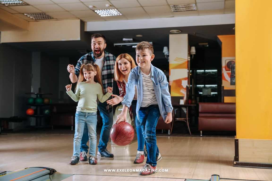 Family Entertainment Center where a kid with his family is throwing a bowling ball